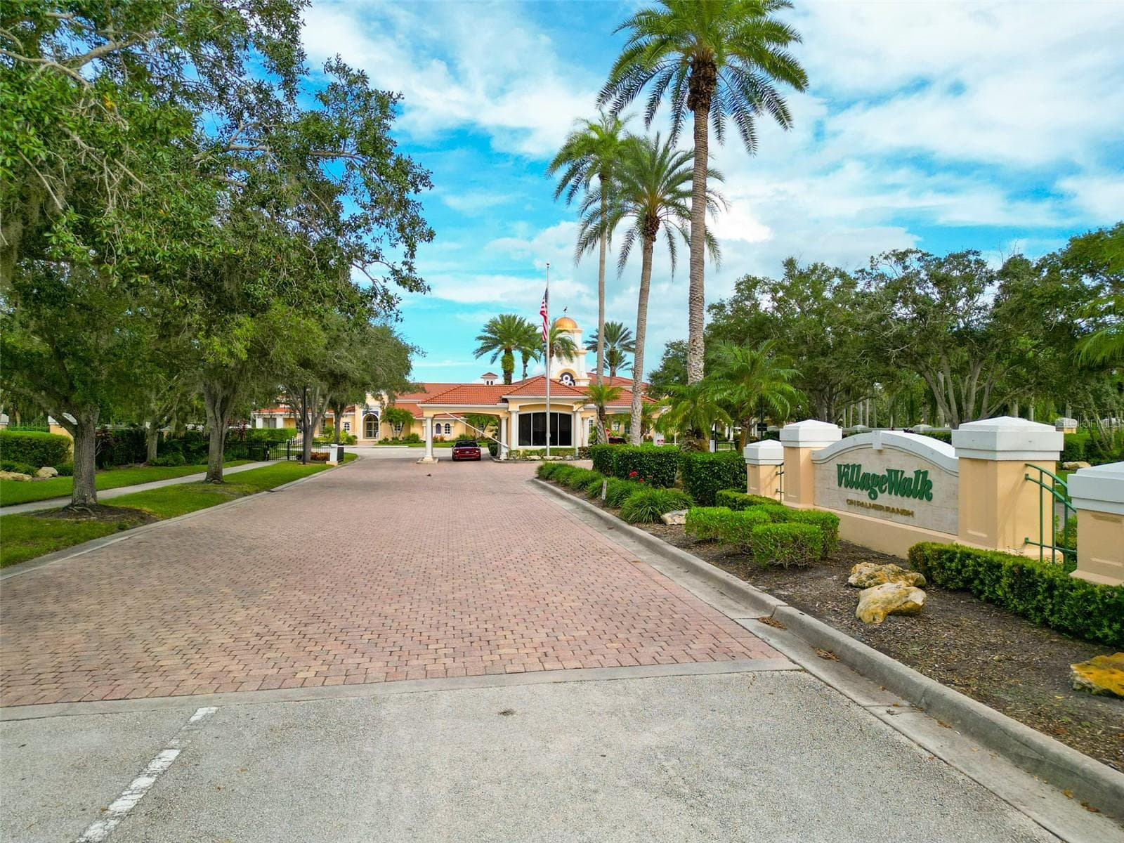 Community exit with view of guard gate and community sign. - 8876 ESTEPONA CT, SARASOTA