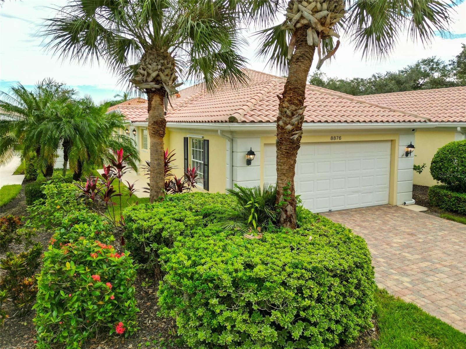Corner shot of residence revealing the garage on the front of the home and entrance on the side. - 8876 ESTEPONA CT, SARASOTA