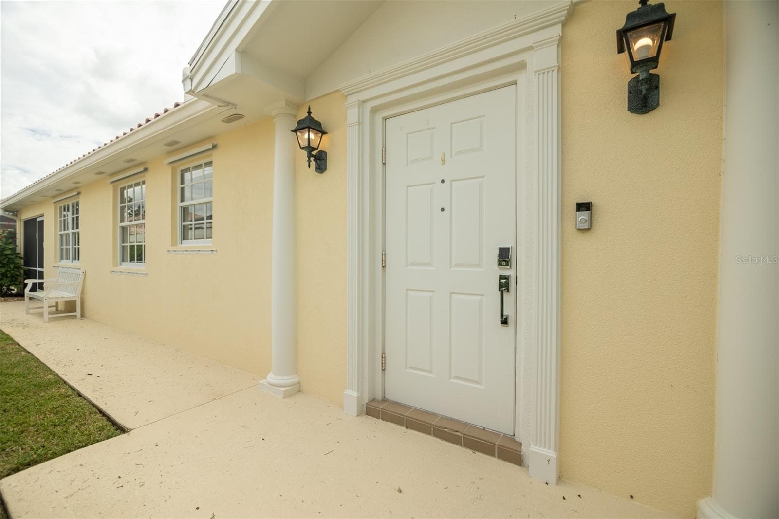View of walk way leading to front door and beyond to the seprate pool entrance. - 8876 ESTEPONA CT, SARASOTA