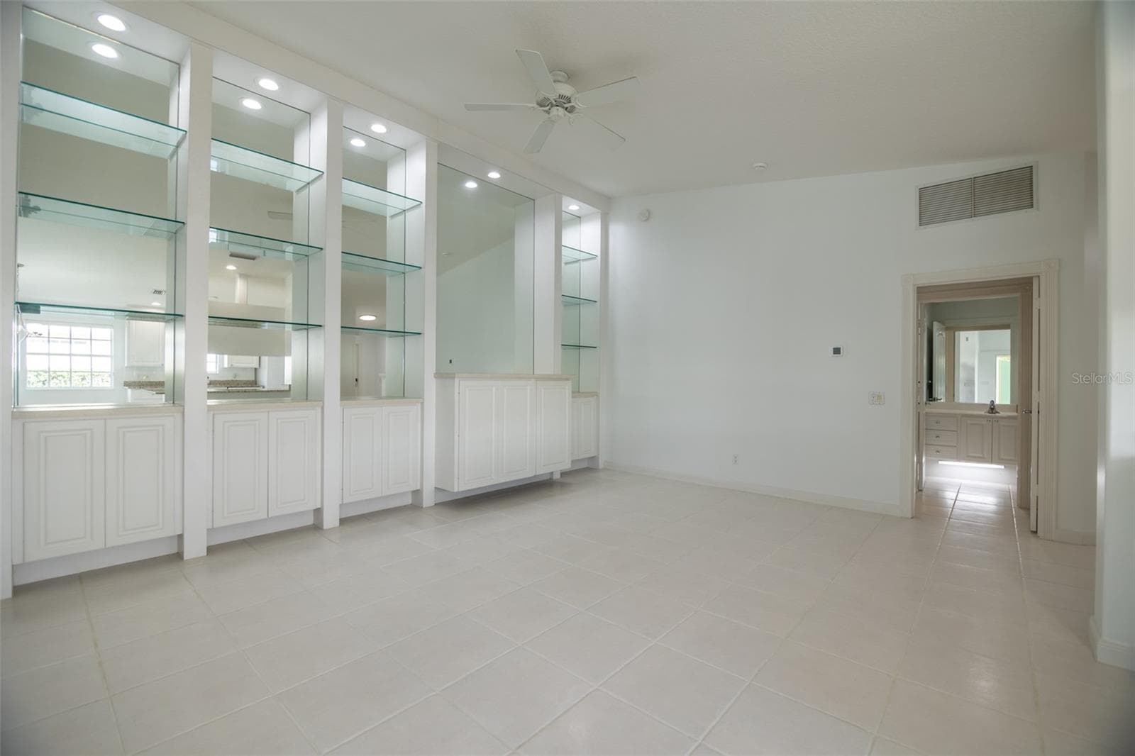 Formal living room with view of guest bathroom. - 8876 ESTEPONA CT, SARASOTA