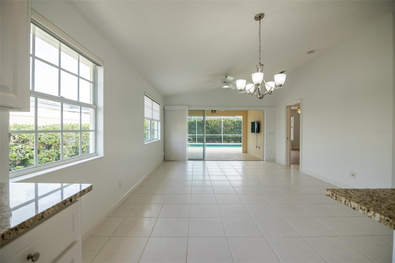 Dining and or living room with views to the pool. - 8876 ESTEPONA CT, SARASOTA