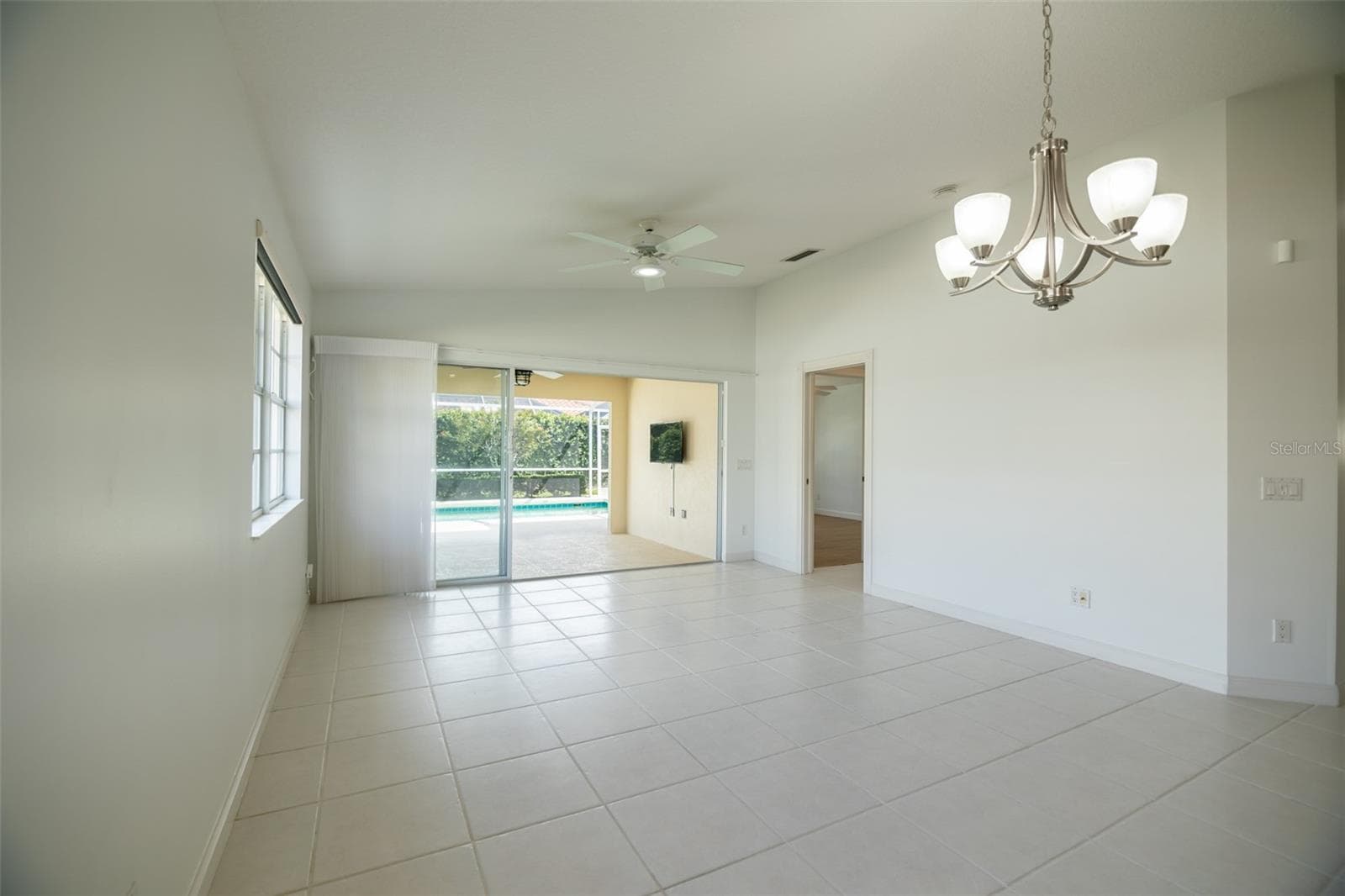 Dining and or living room with views to the pool and primary suite. - 8876 ESTEPONA CT, SARASOTA