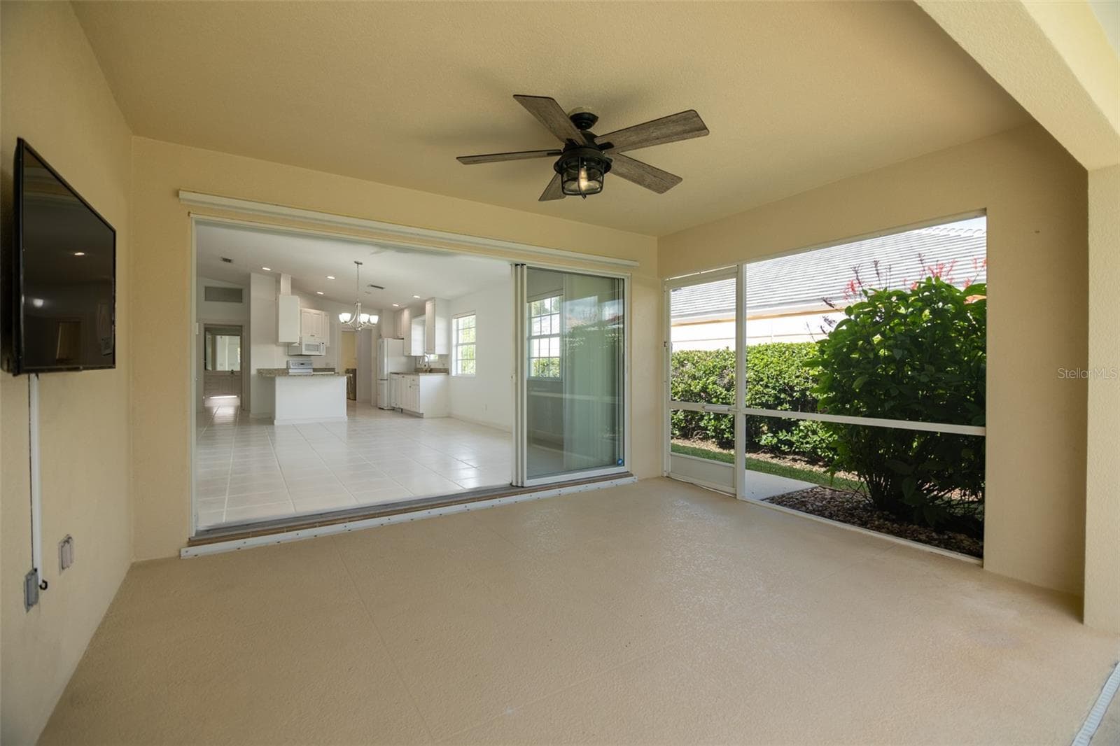 Back patio with view of Living room and Kitchen. - 8876 ESTEPONA CT, SARASOTA