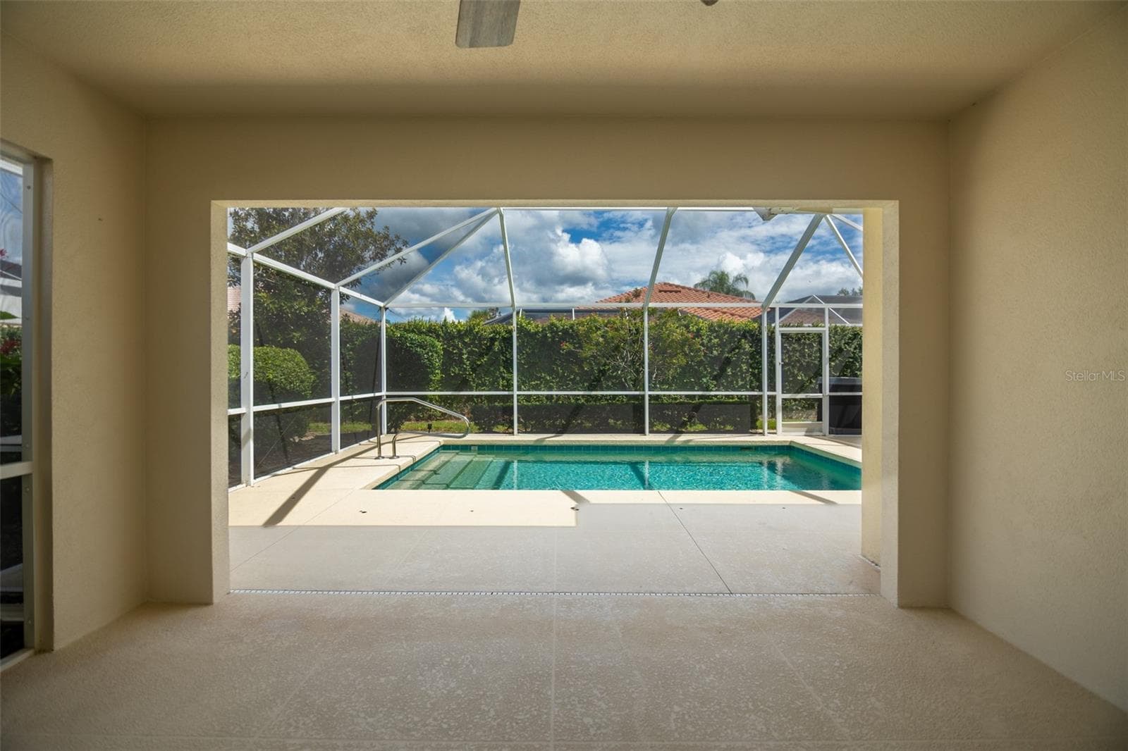Back patio screen door on left with view of the pool in the center. - 8876 ESTEPONA CT, SARASOTA
