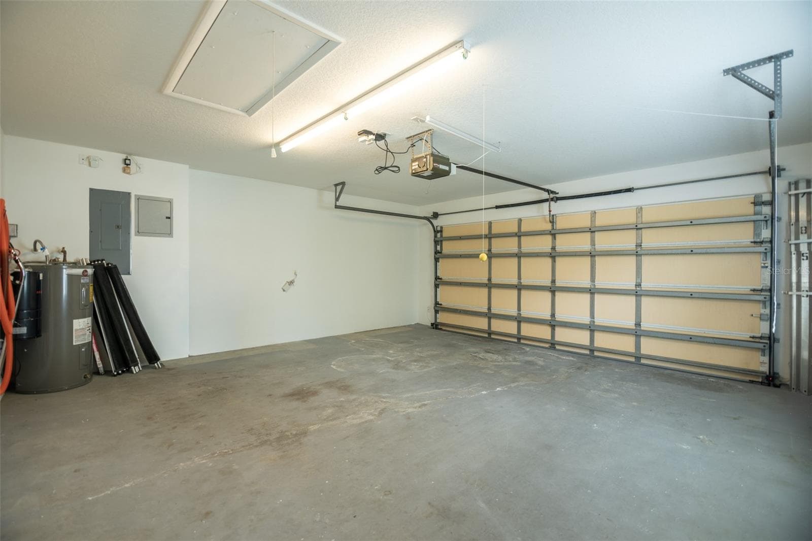 Garage with a vaccume and pool safety fence. - 8876 ESTEPONA CT, SARASOTA