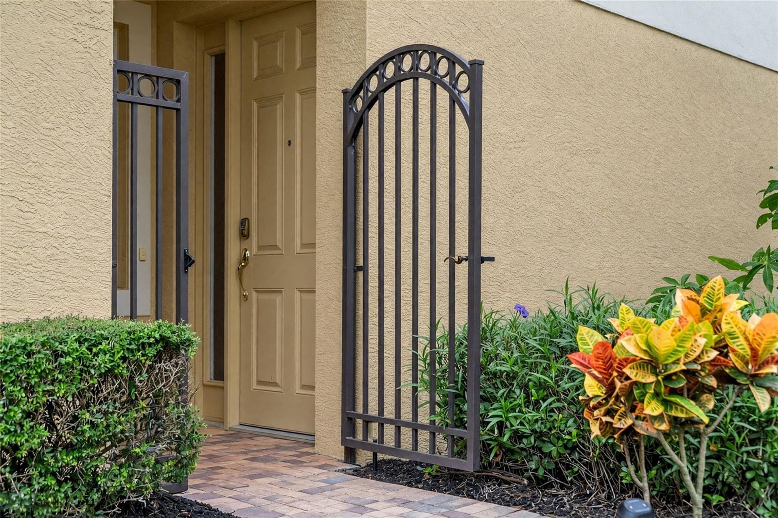 A tucked-away gated entrance adds privacy and a convenient spot for deliveries. - 8432 MIRAMAR WAY, LAKEWOOD RANCH