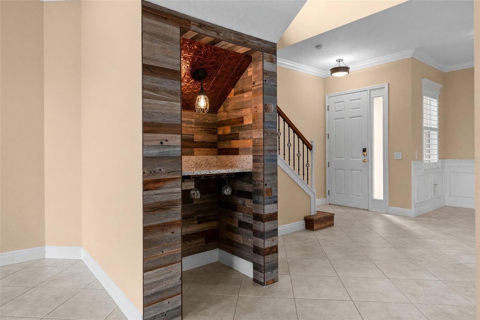 Wood accents, a decorative ceiling, and pendant lighting make this custom wine nook a conversation piece. - 8432 MIRAMAR WAY, LAKEWOOD RANCH
