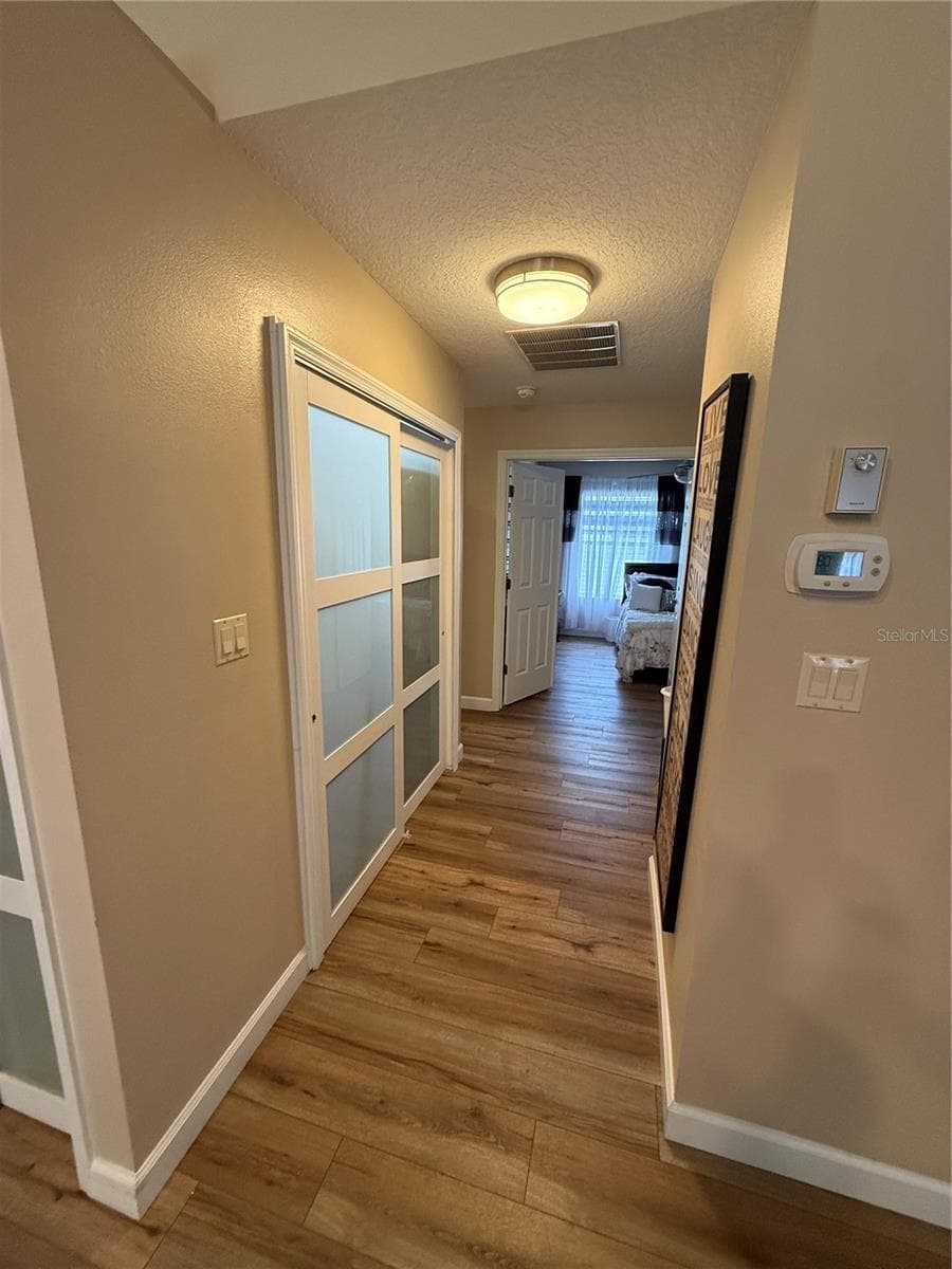 hall from kitchen to bedrooms passing laundry - 24907 CRANES ROOST CIR, LEESBURG