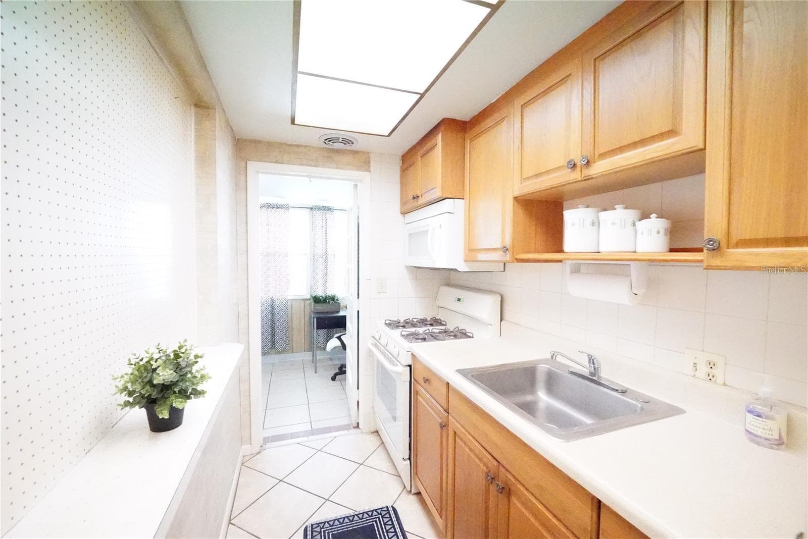 Kitchen with door open toward FL room - 5810 21ST ST N #15, ST PETERSBURG