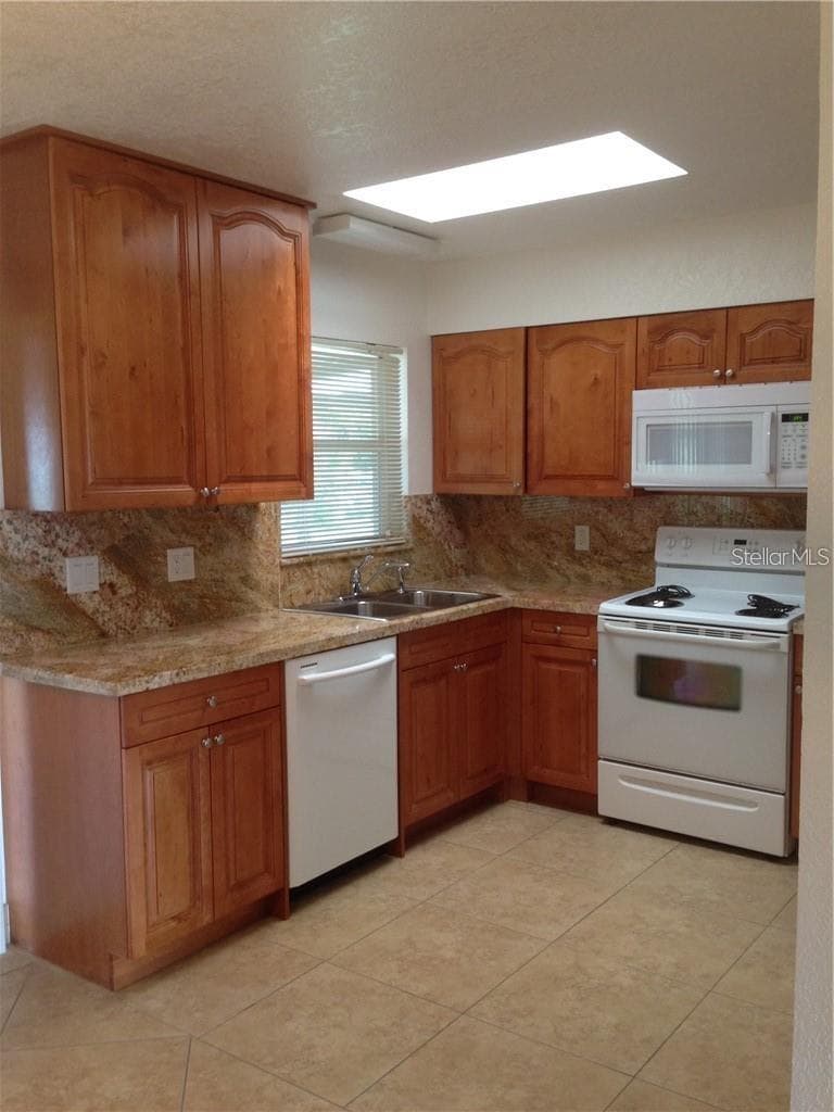KITCHEN W/CERAMIC TILE, GRANITE COUNTERS, WOOD CABINETS - 23040 JUMPER AVE, PORT CHARLOTTE