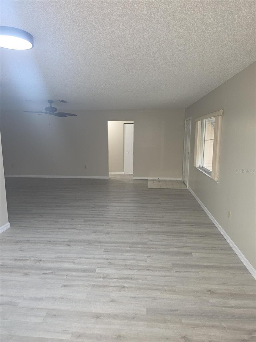 Great room with new luxury vinyl plank flooring - 10765 SW 63RD TER, OCALA