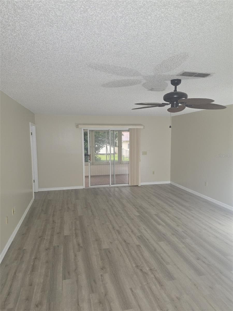 Family room with sliding doors to the enclosed lanai - 10765 SW 63RD TER, OCALA