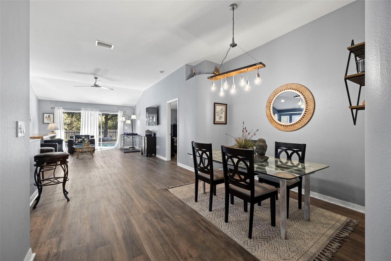 An open floor plan greets you with a dining area, living room and kitchen with access to the pool, pond views and conservation. - 7831 STONELEIGH DR, LAND O LAKES