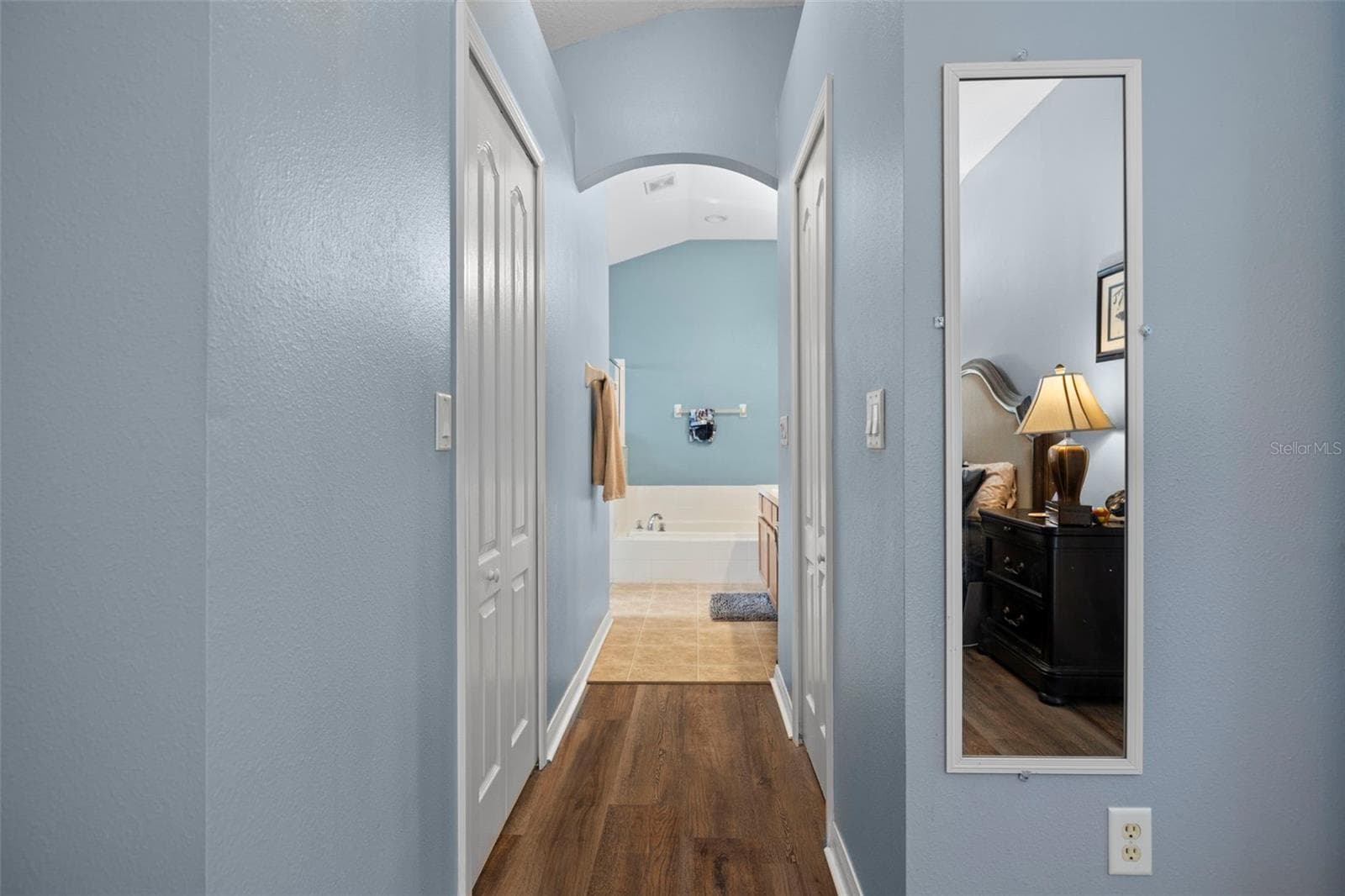 His and hers walk-in closets lead to the primary bathroom - 7831 STONELEIGH DR, LAND O LAKES
