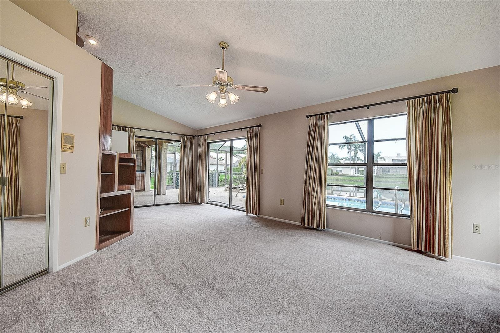 Primary Bedroom with a view of the Pool and Pond - 3609 DARSTON ST, PALM HARBOR
