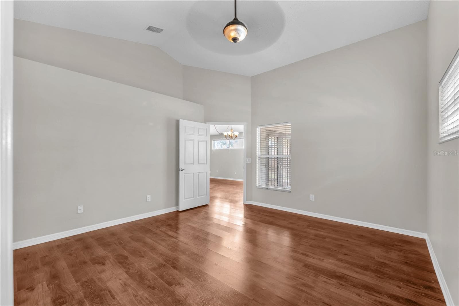 A view from the primary bedroom into the great room. - 4002 LEVONSHIRE PL, VALRICO