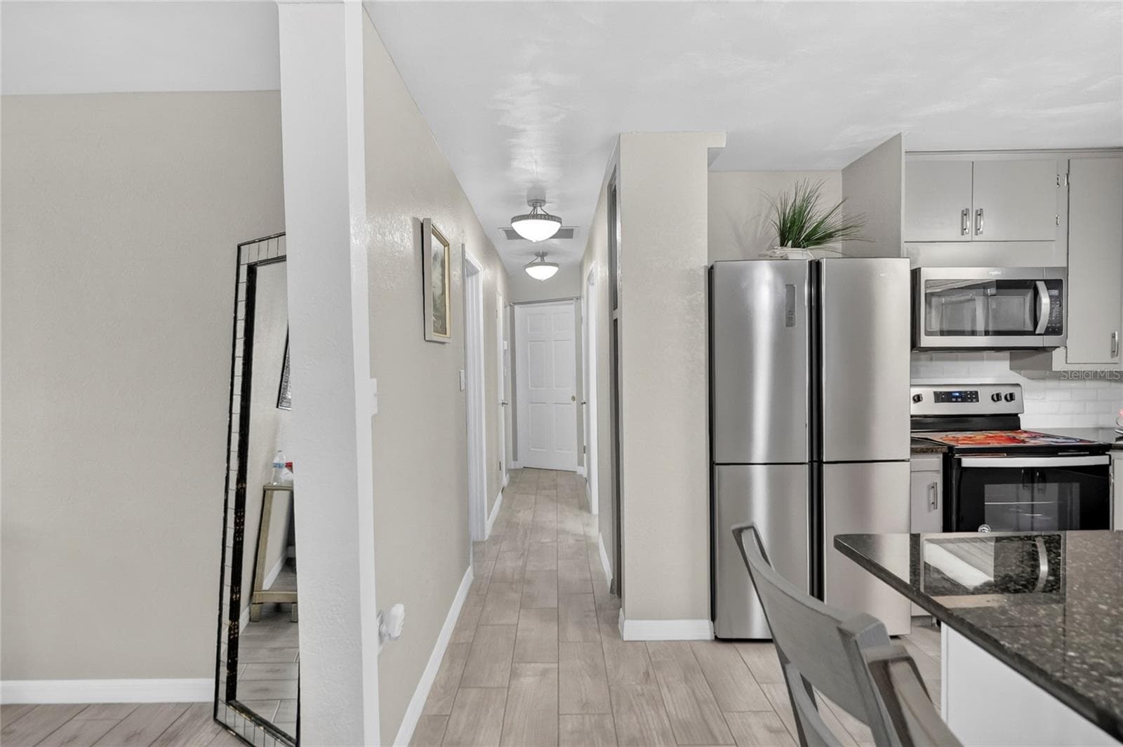 Hallway to the 3 bedrooms and 2 bathrooms - 1075 8TH ST NW, WINTER HAVEN