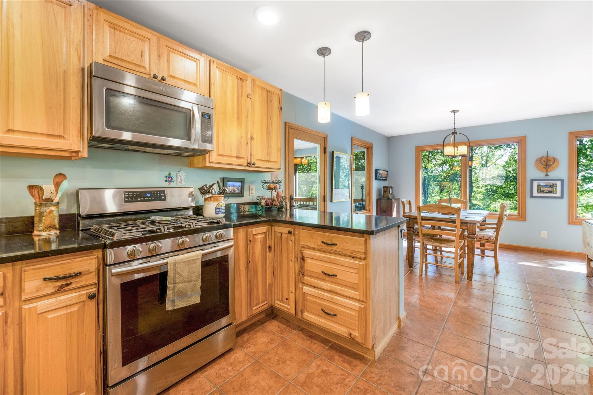 Kitchen located next to the screened porch and the dining room, which makes entertaining easy. - 115 Laurel Wood Drive, Mars Hill