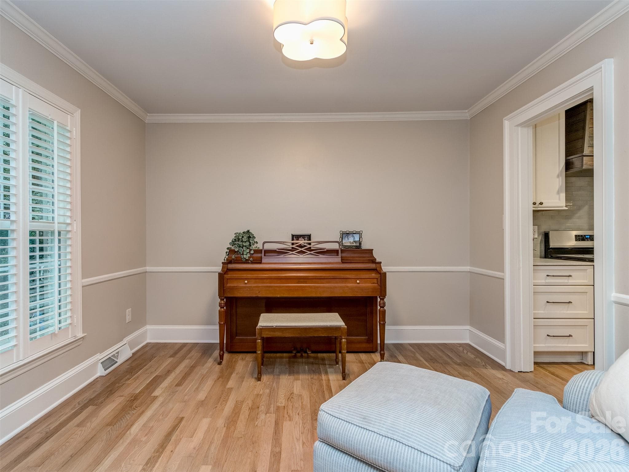 The den is a perfect place for a large home office, study, or music studio! Site finished hardwoods, extensive molding, & custom blinds are present throughout the main living areas. - 6129 Page Court, Charlotte