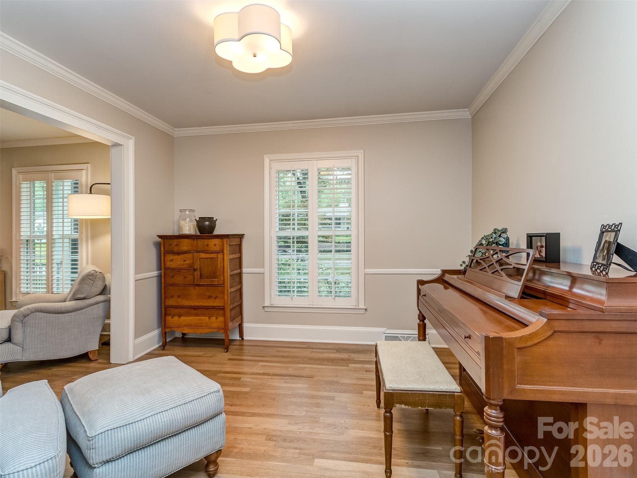The den is a perfect place for a large home office, study, or music studio! Site finished hardwoods, extensive molding, & custom blinds are present throughout the main living areas. - 6129 Page Court, Charlotte