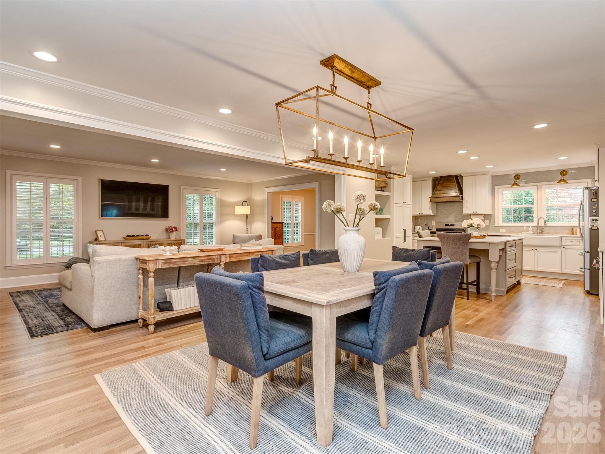 The formal dining room has custom light fixture, gas log fireplace, site finished hardwood flooring, & is perfectly situated between the kitchen, great room, & screened porch! - 6129 Page Court, Charlotte