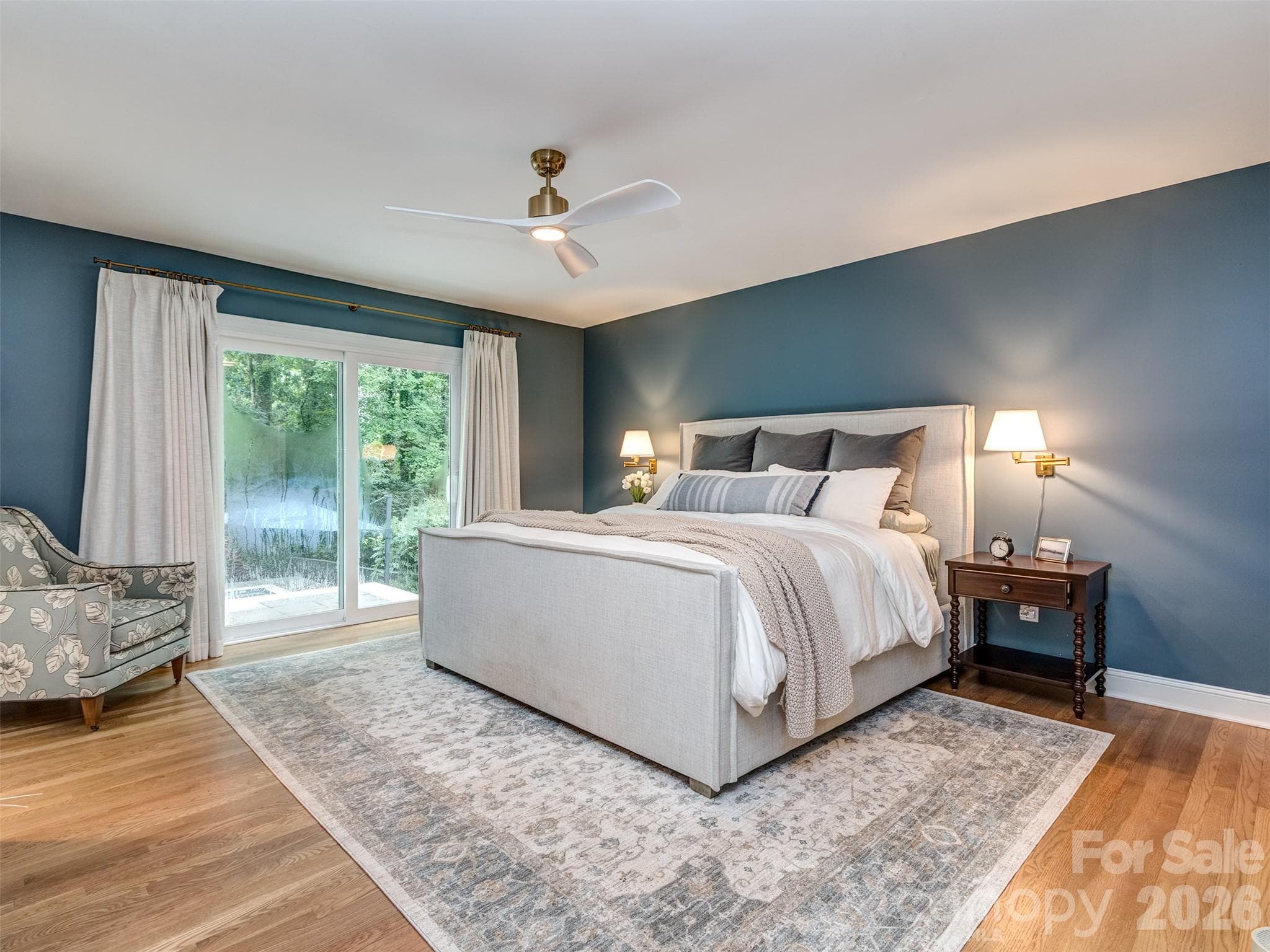 The newly reimagined Primary Suite is much larger now at 14'11" x 21'3". The site finished hardwoods, custom fireplace & newly constructed primary patio that leads to your pool & spa! - 6129 Page Court, Charlotte