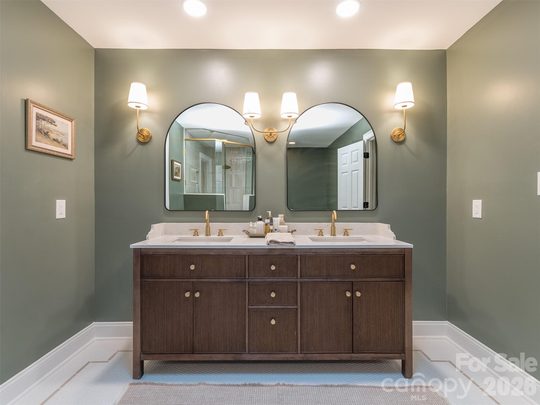 The primary bath is now much larger and features custom tile flooring with inlays, dual custom vanity with sconce lighting, claw foot soaking tub with floor mount, & oversized walk-in shower! - 6129 Page Court, Charlotte