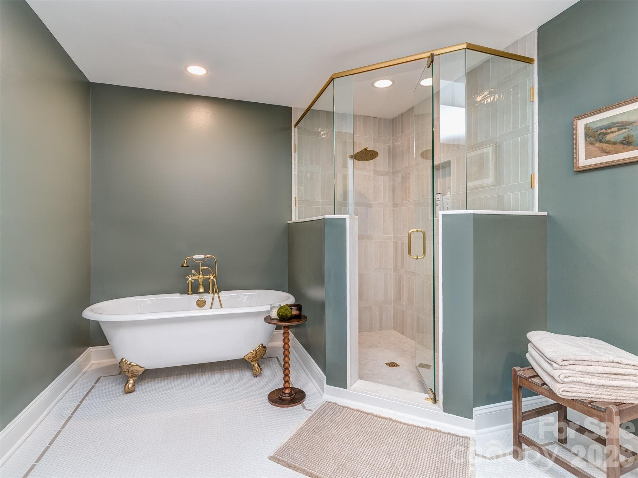 The primary bath is now much larger and features custom tile flooring with inlays, dual custom vanity with sconce lighting, claw foot soaking tub with floor mount, & oversized walk-in shower! - 6129 Page Court, Charlotte