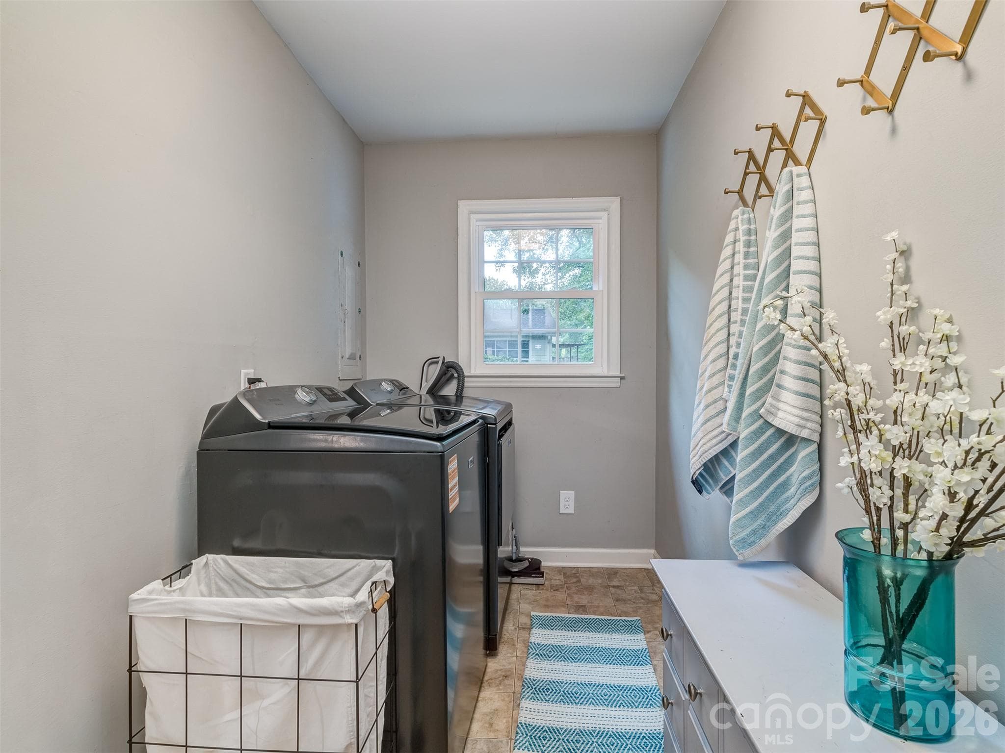 Large Laundry Room has custom drop zone area and tile flooring. - 6129 Page Court, Charlotte