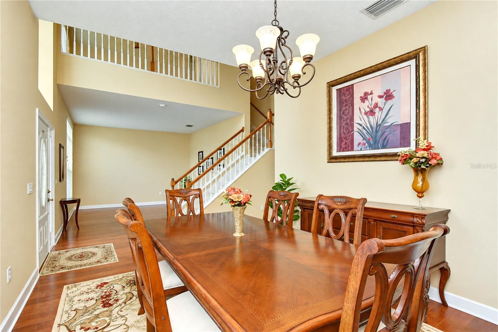 Formal dining area featuring an open view of the grand two-story staircase. - 5104 WHISPERING LEAF TRL, VALRICO