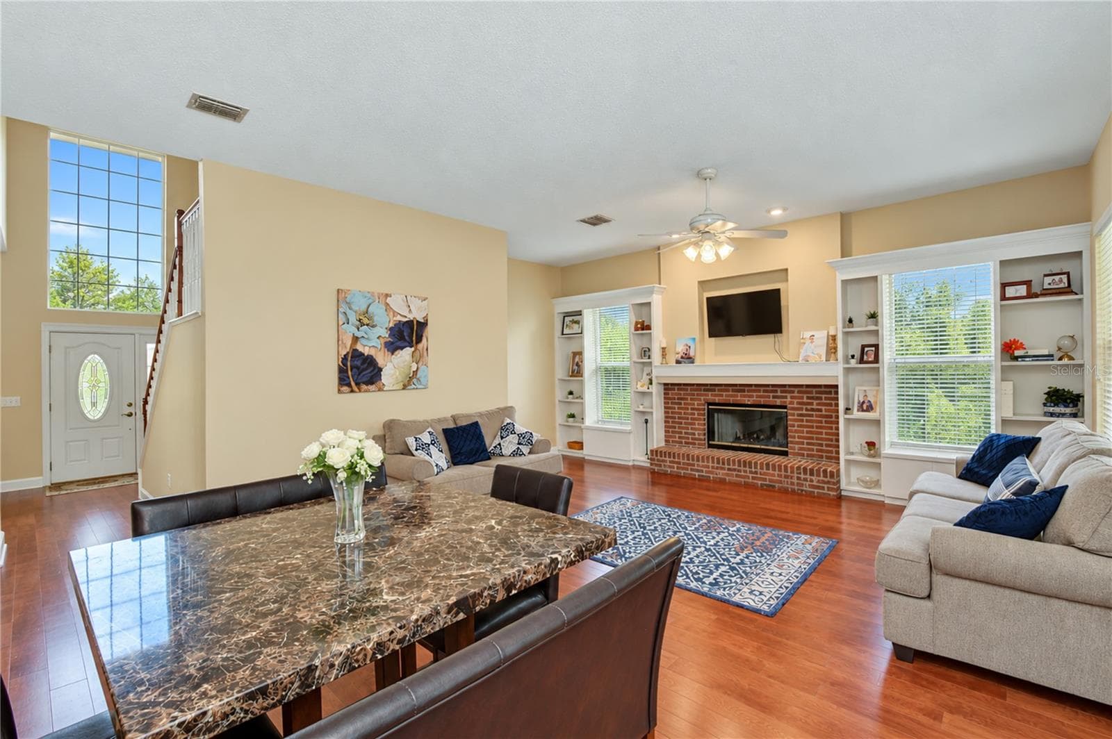 Comfortable gathering space with views of the backyard. - 5104 WHISPERING LEAF TRL, VALRICO