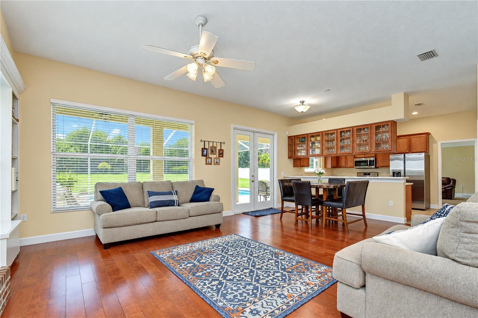 Enjoy views of the private outdoor retreat from the family room. - 5104 WHISPERING LEAF TRL, VALRICO