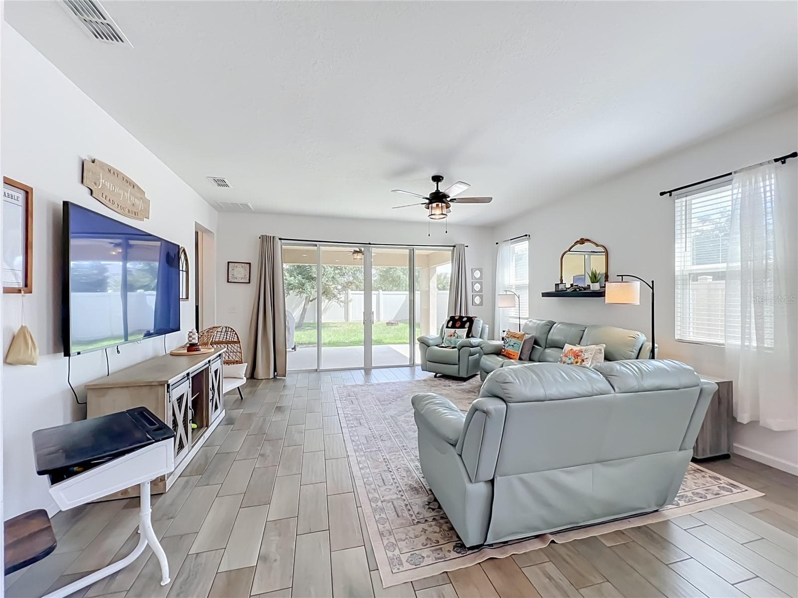 LIVING ROOM WITH SLIDERS TO PATIO - 1244 STRATTON AVE, GROVELAND