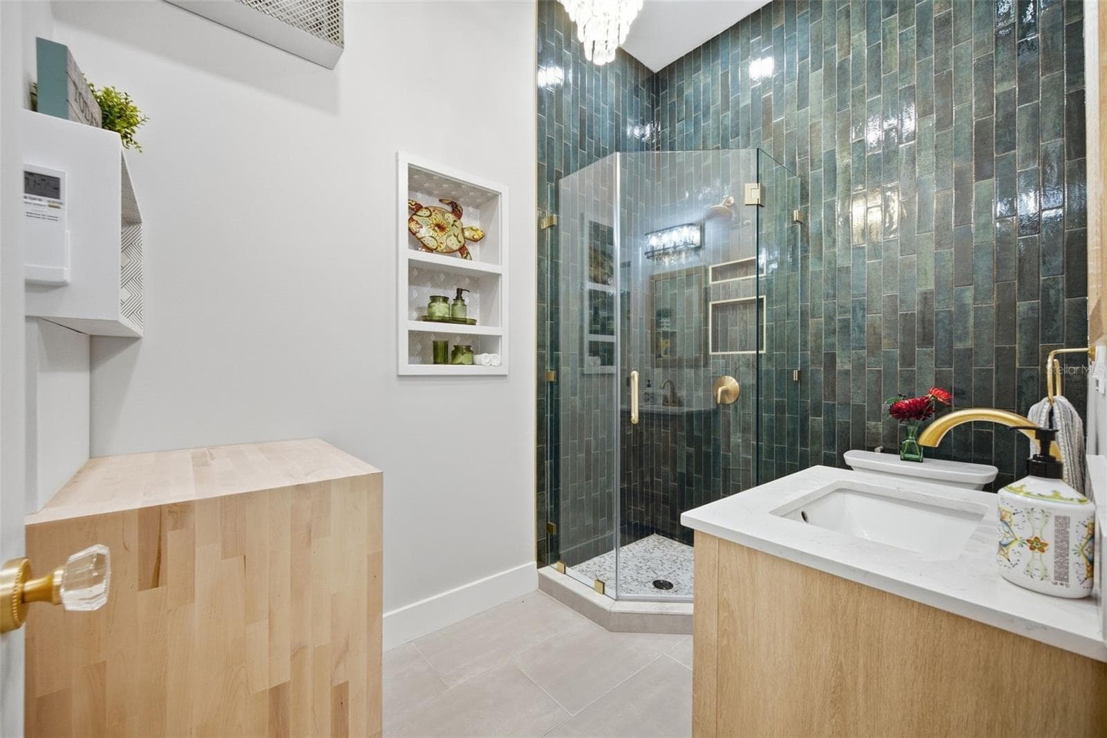 Striking primary en suite with dramatic floor-to-ceiling tile, frameless glass shower - 5837 TENNESSEE AVE, NEW PORT RICHEY