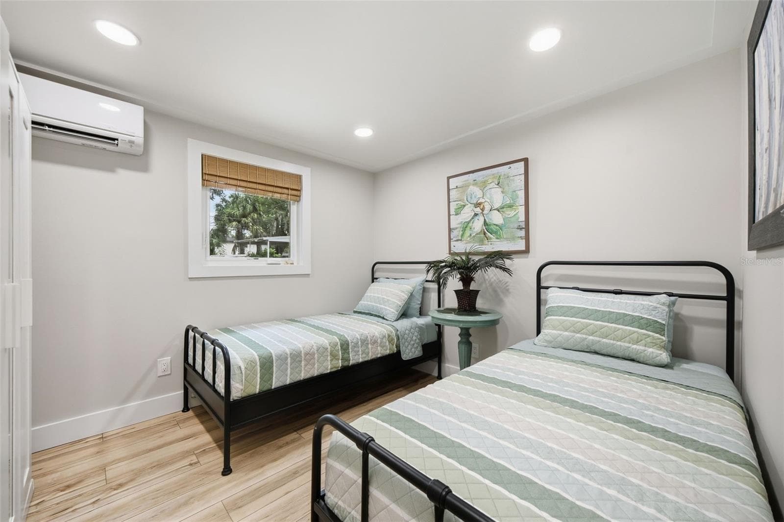 Second bedroom with room for two beds, ample closet space and dedicated climate control. - 5837 TENNESSEE AVE, NEW PORT RICHEY