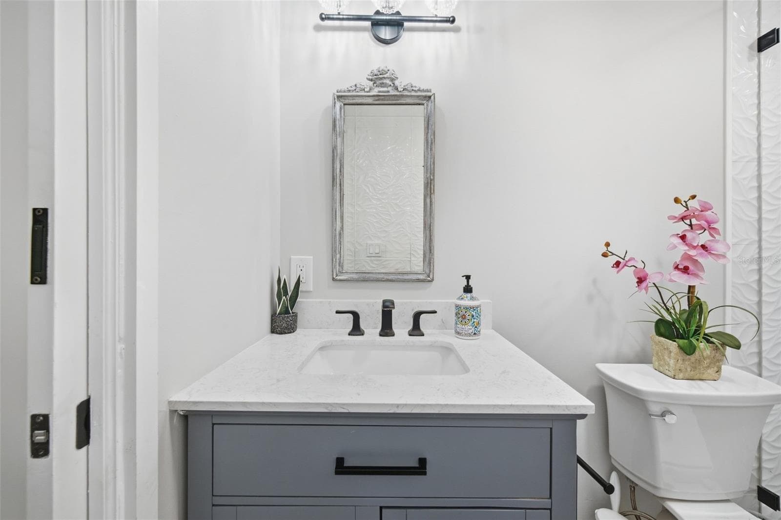 Quartz vanity and striking matte-black accents. - 5837 TENNESSEE AVE, NEW PORT RICHEY