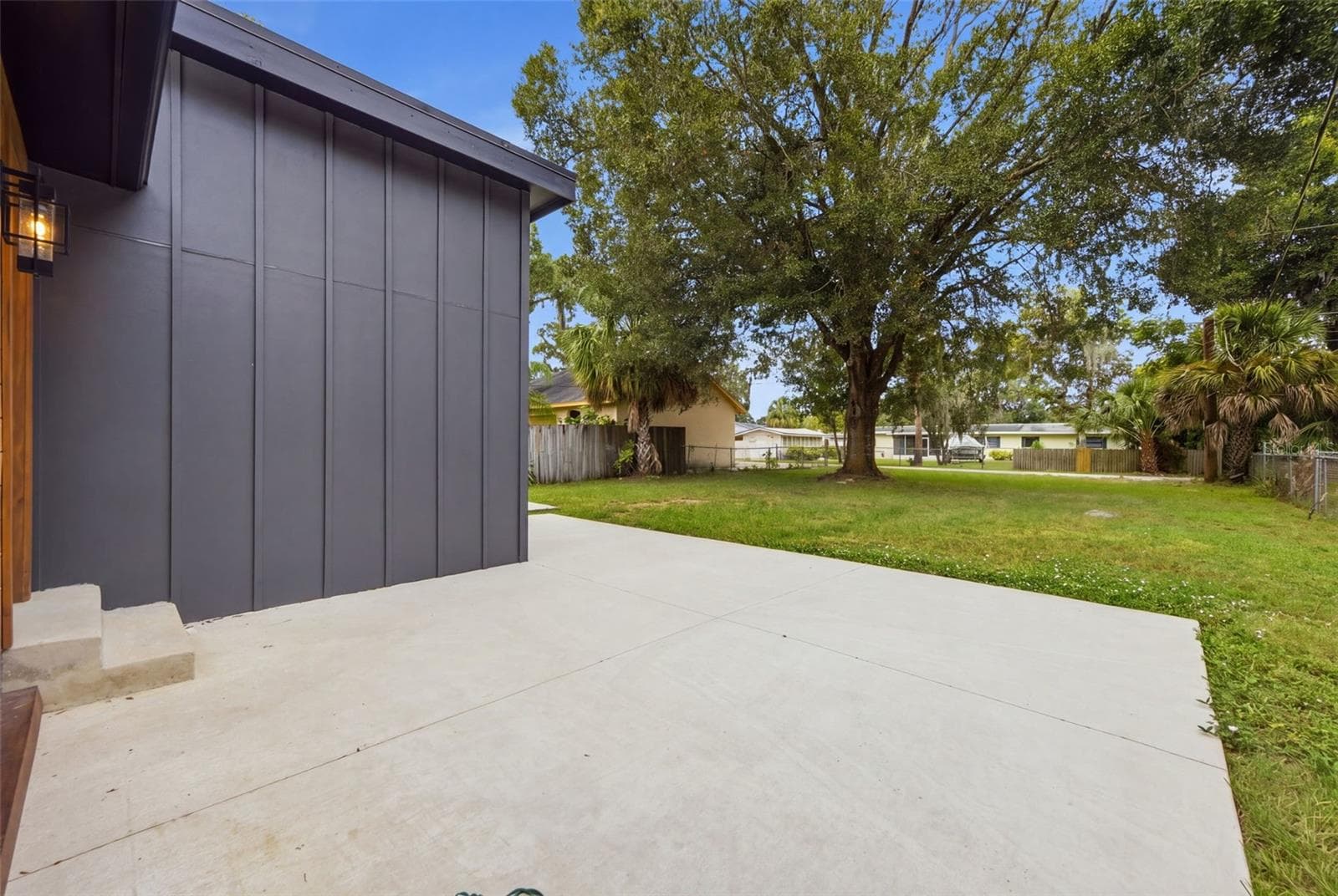 Expansive concrete patio provides versatile space for outdoor dining, entertaining, grilling or relaxing - 5837 TENNESSEE AVE, NEW PORT RICHEY