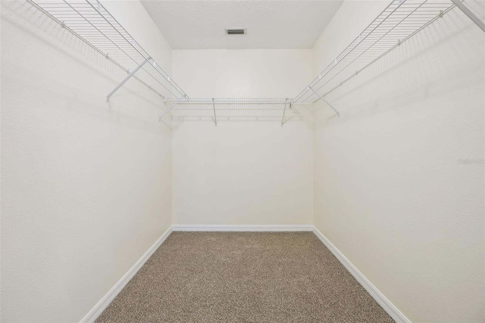 Primary walk-in closet (6'4" x 8'11") with new wire shelving - 2020 PORTCASTLE CIR, WINTER GARDEN