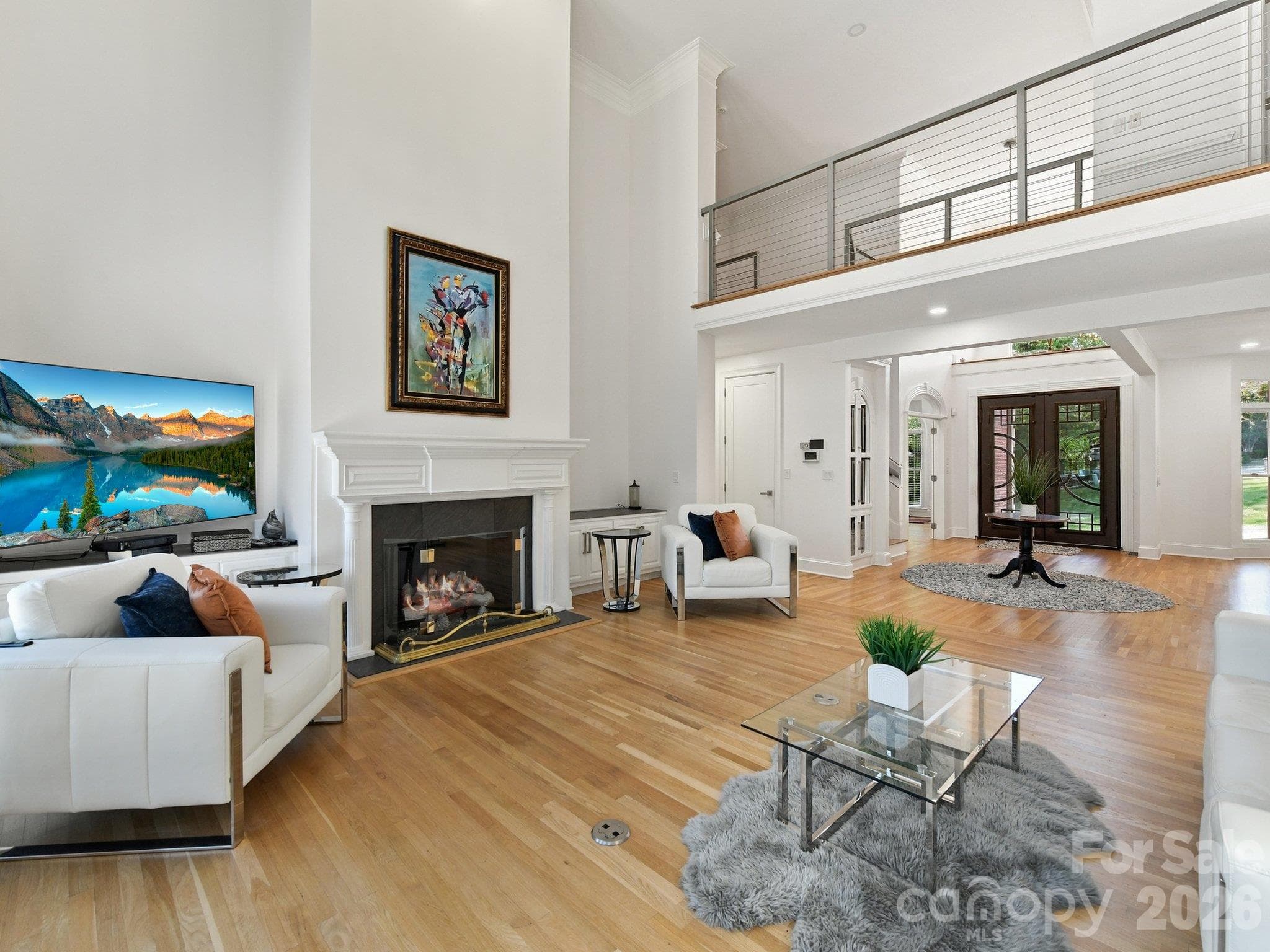 A soaring 2-story great room with a floor-to-ceiling fireplace. - 2723 Providence Pine Lane, Charlotte