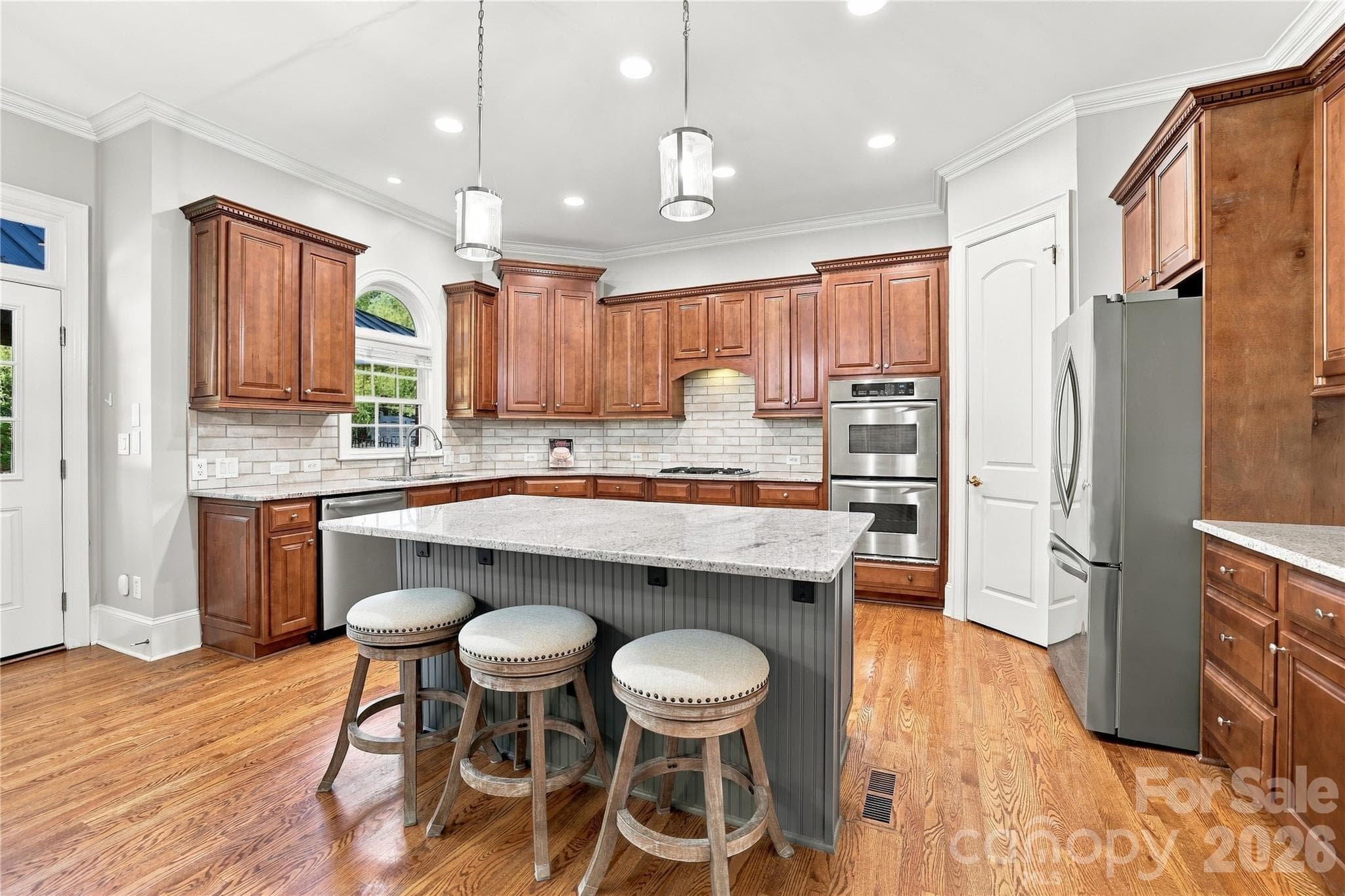 This is a kitchen made for people who actually like to cook. Generous counter space, abundant cabinets, a large center island and double wall ovens provide plenty of room for serious meal prep, while island seating keeps family and guests close to the action. - 2309 Highland Forest Drive, Waxhaw