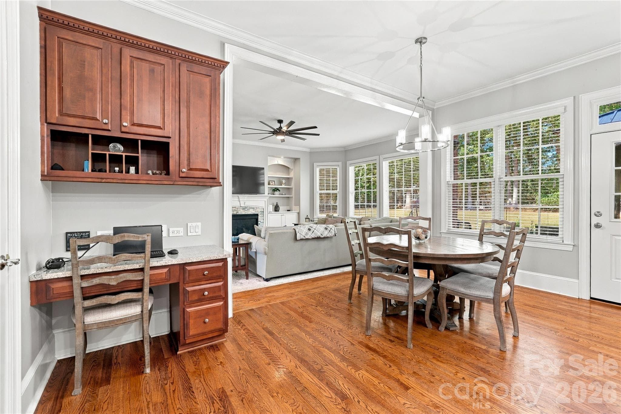 The spacious breakfast area handles much more than a quick morning meal, with room for a full-size table, walls of windows overlooking the backyard and a built-in desk that gives you a convenient spot for a laptop, homework or keeping the household organized. - 2309 Highland Forest Drive, Waxhaw