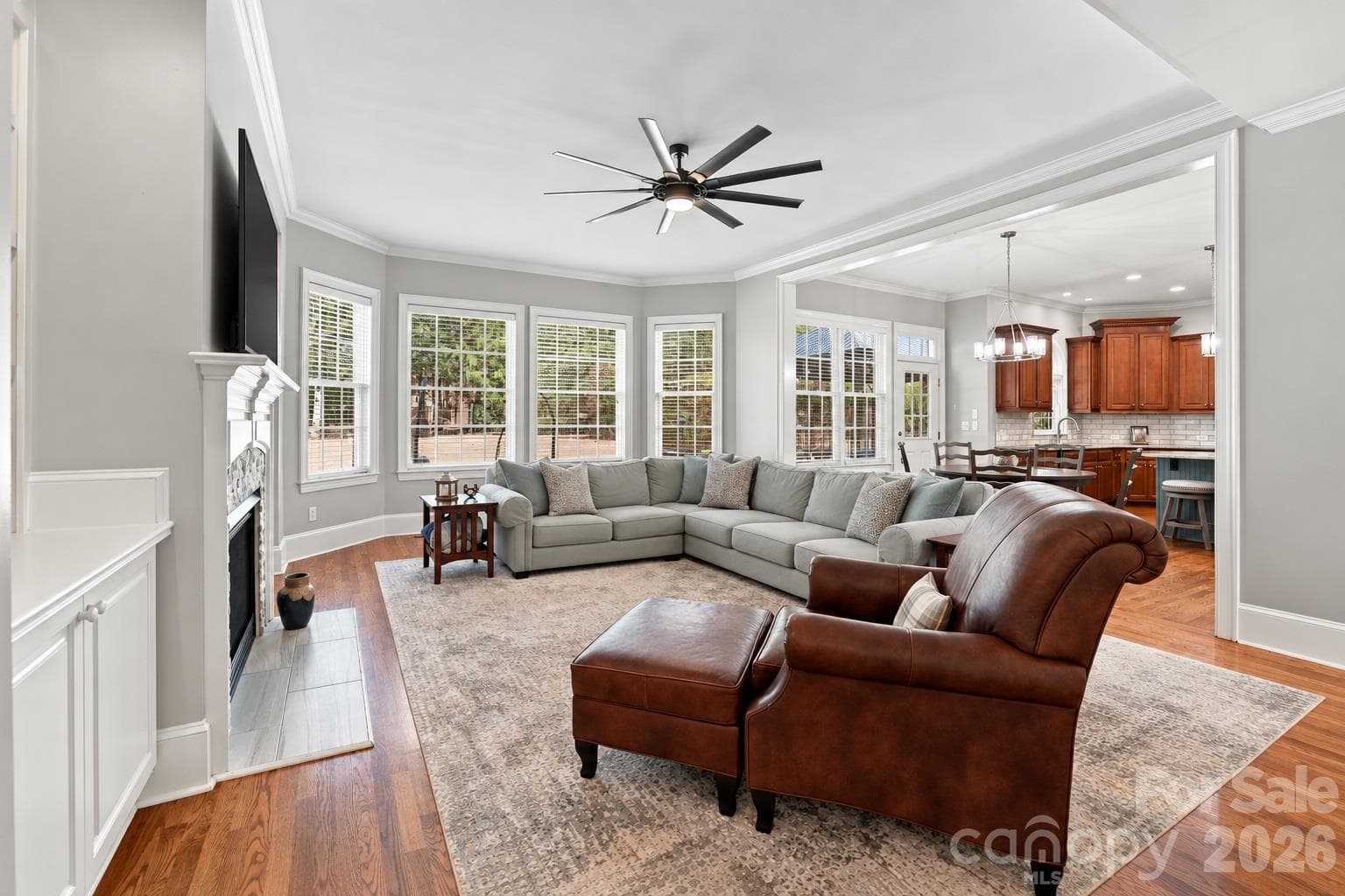 A great room that lives up to its name. Its size has room for big, comfortable furniture while a wall of windows brings in the backyard views and natural light — a room designed for everything from Sunday afternoons to holiday gatherings. - 2309 Highland Forest Drive, Waxhaw