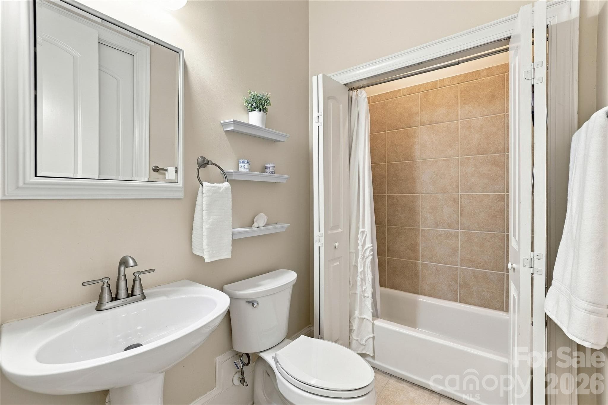 Full bathroom on home's main floor accessed from both the adjoining bedroom and hallway. - 2309 Highland Forest Drive, Waxhaw
