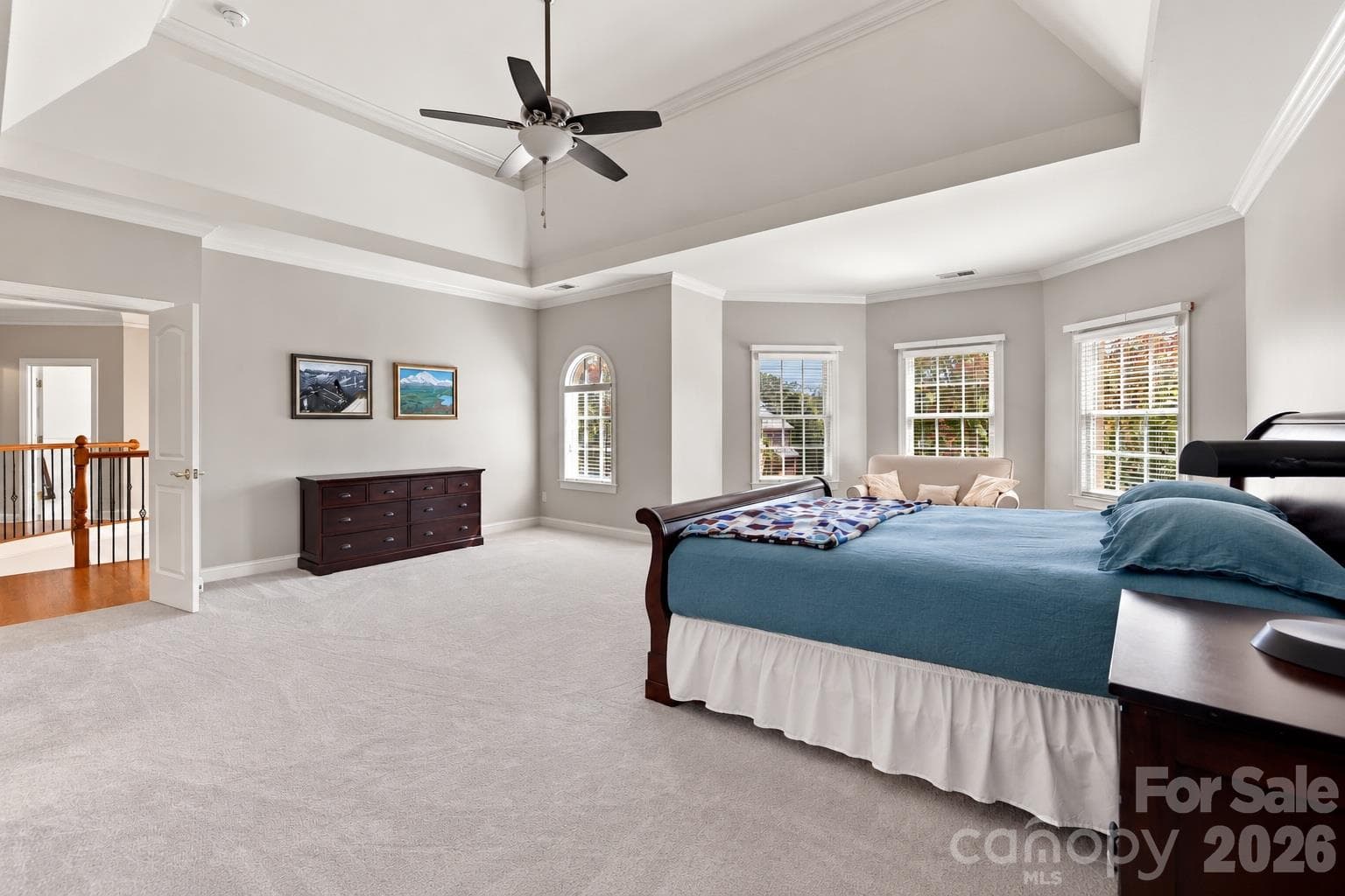 The scale of this primary suite is especially apparent from this angle. With broad stretches of open floor space and windows on three sides, it has the proportions and architectural presence you expect in a luxury home rather than feeling like simply another large bedroom. - 2309 Highland Forest Drive, Waxhaw