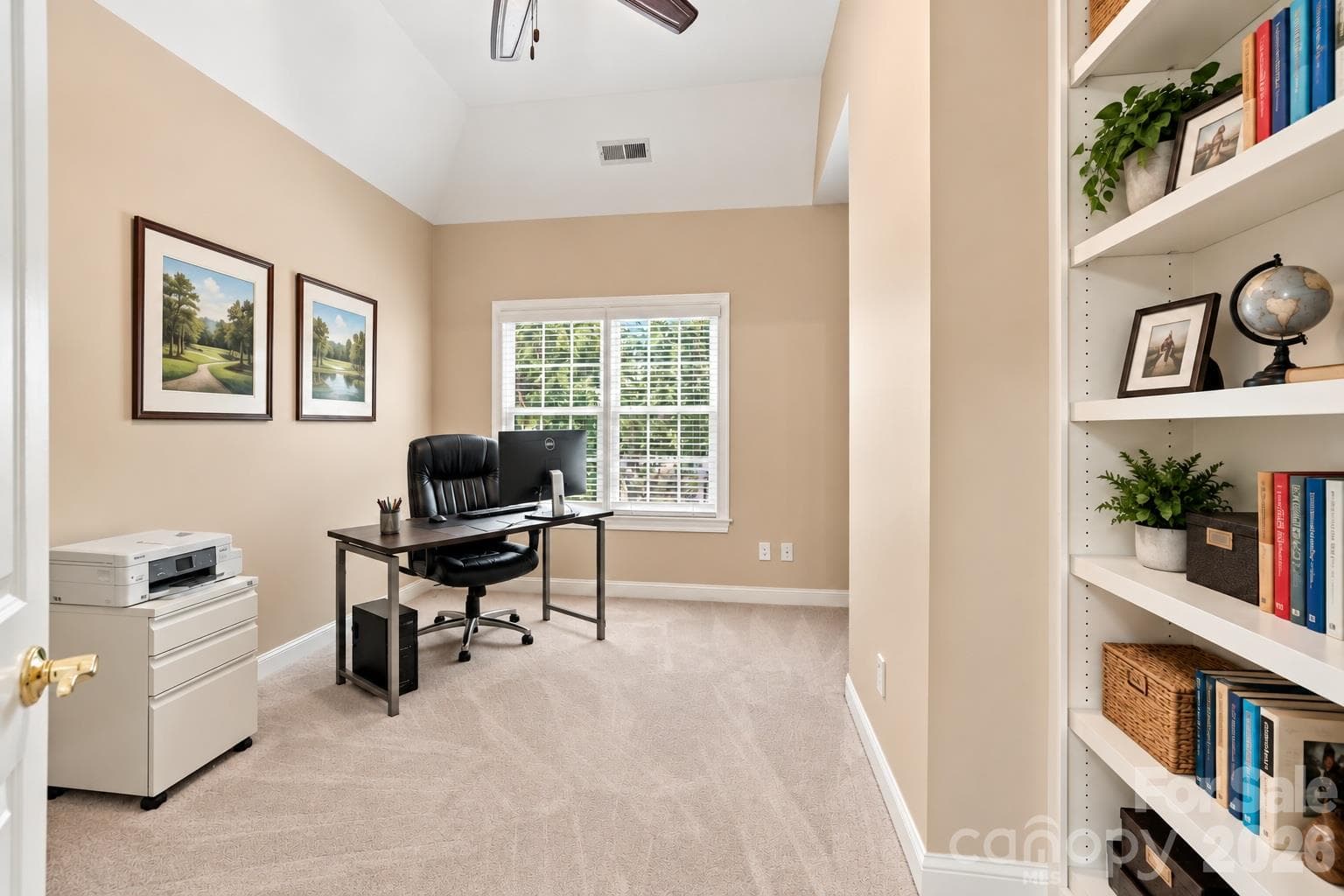 Tucked behind the primary bath, this private office or library is a terrific bonus within the primary suite. Built-in bookshelves offer  space for books, files and display pieces, while two windows bring in plenty of natural light. Best of all, its location creates a quiet, private place to work or read away from the activity in the rest of the home. - 2309 Highland Forest Drive, Waxhaw