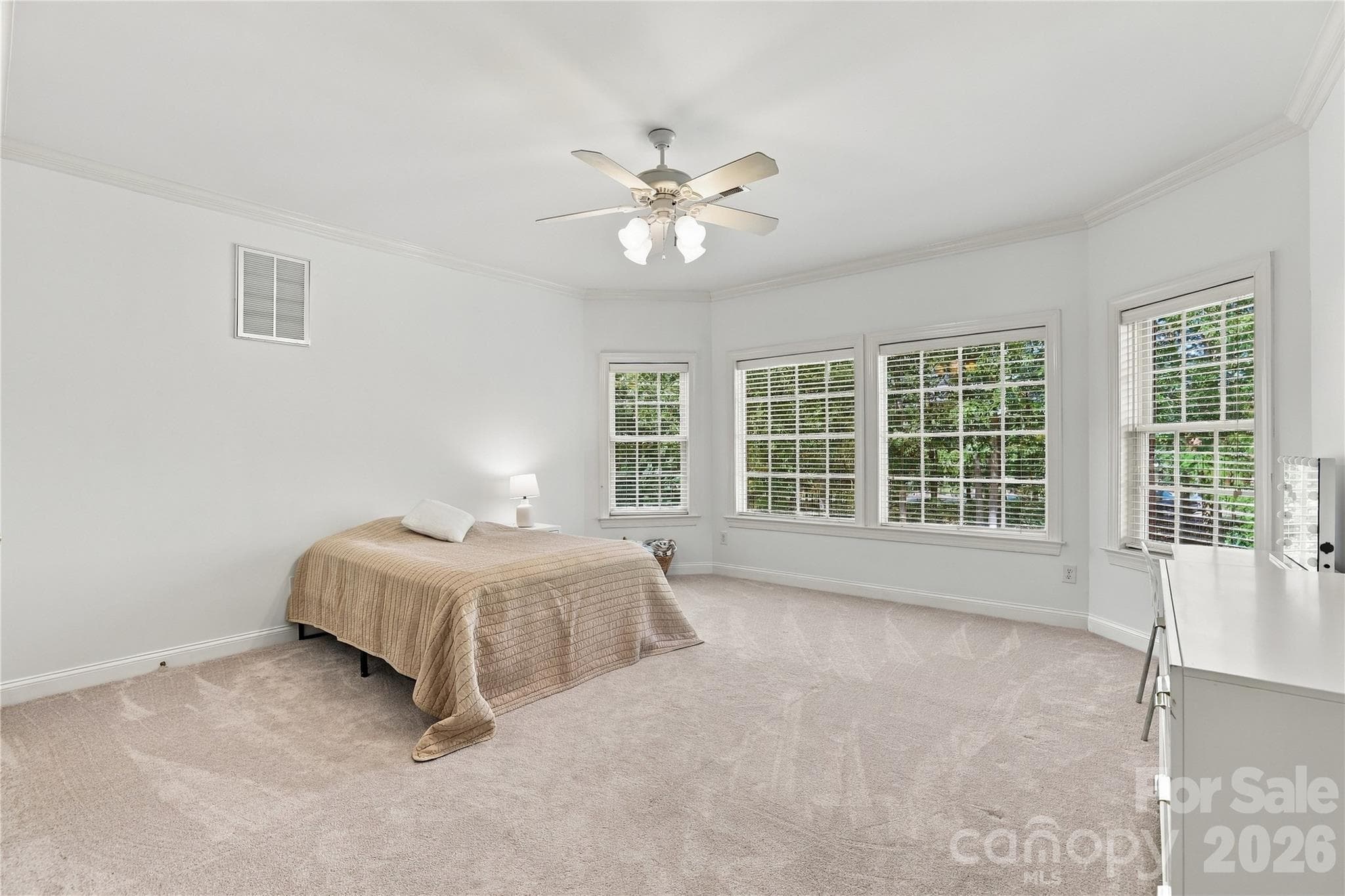 One of four additional bedrooms on the home’s second floor, this generously sized room offers plenty of space for a sitting area, study space or hobbies in addition to everything you’d expect in a comfortable bedroom. - 2309 Highland Forest Drive, Waxhaw