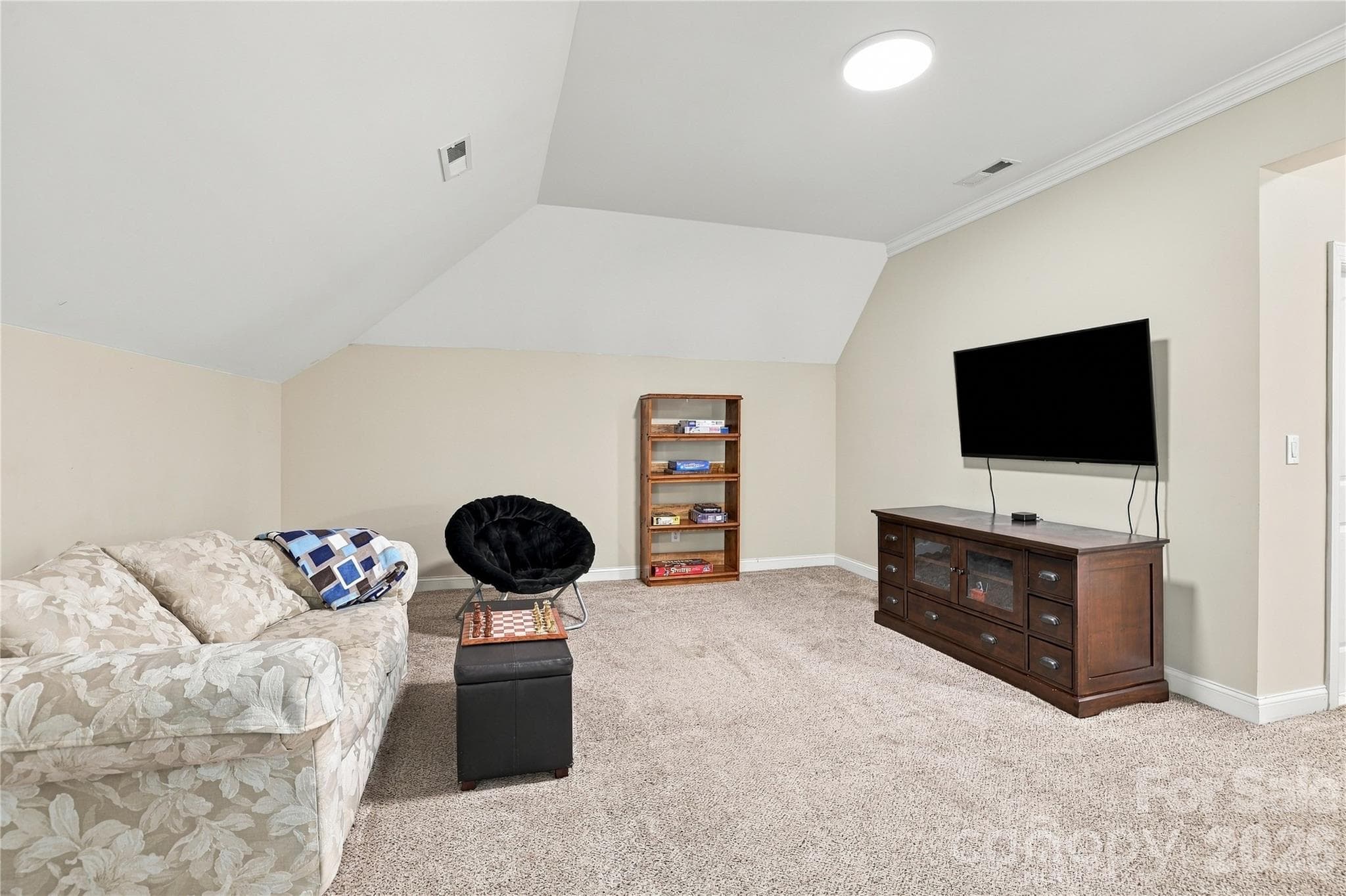 There’s more to the finished third floor than recreation. This separate area has plenty of room for comfortable seating and a large-screen TV, making it an ideal media room, movie space or casual hangout away from the home’s main living areas. - 2309 Highland Forest Drive, Waxhaw