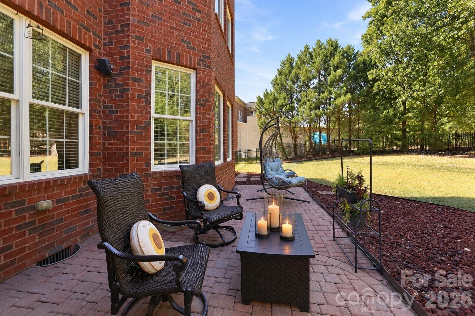 The brick paver patio creates an inviting place to take life outside, with plenty of room for comfortable seating and space to relax with a morning cup of coffee, settle in with a good book or unwind at the end of the day. - 2309 Highland Forest Drive, Waxhaw