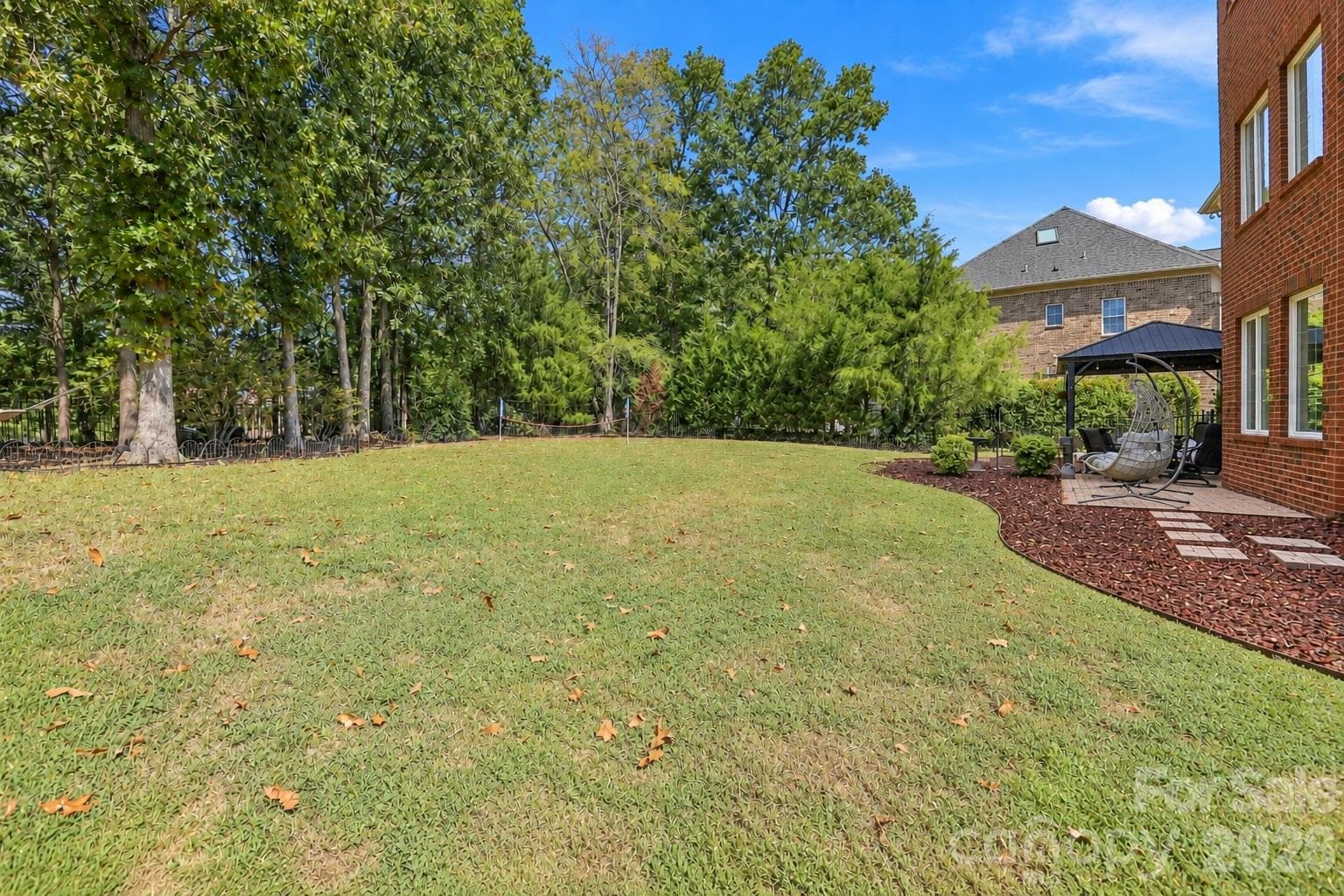A backyard with this much flat, usable space gives you options. There’s room for pets to run, games on the lawn, gardens, additional outdoor living areas or simply relaxing outside. Fully fenced and surrounded by mature trees that add privacy, this is a backyard designed to be used. - 2309 Highland Forest Drive, Waxhaw