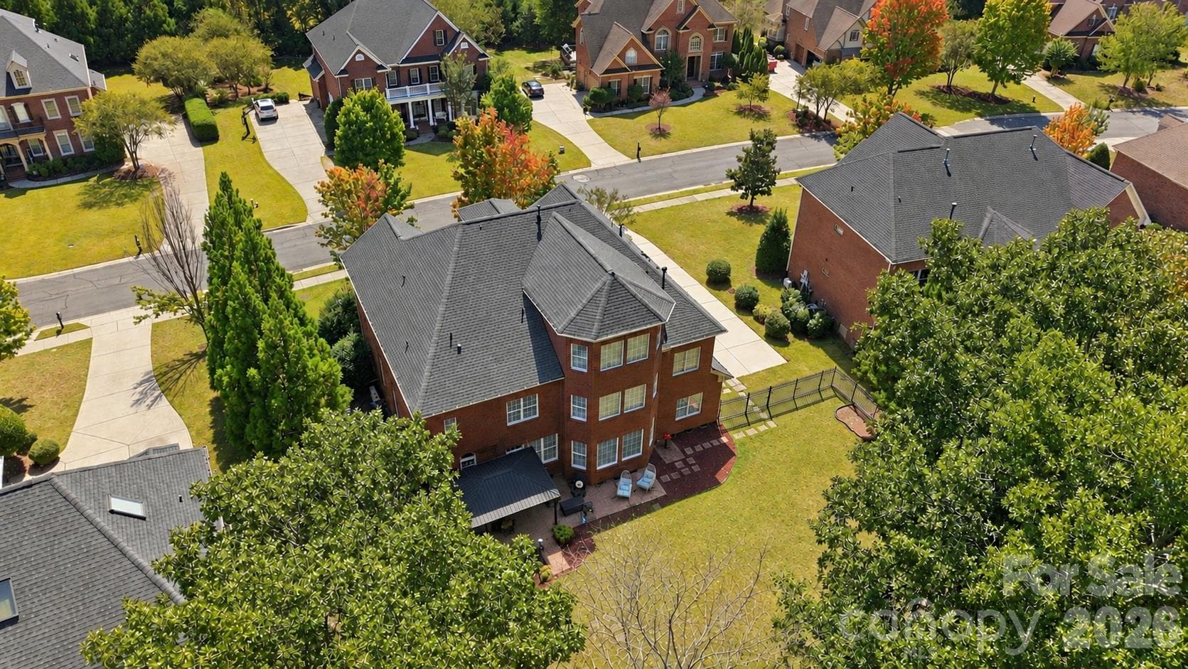 This aerial view puts the size of the homesite into perspective, showing just how much backyard space there is behind the home. It also gives you a better sense of the home’s setting within Weddington Chase and the mature trees surrounding the property. - 2309 Highland Forest Drive, Waxhaw